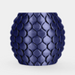 A glossy dark blue textured planter pot with a raised leaf-like pattern, centered on a light gray background.